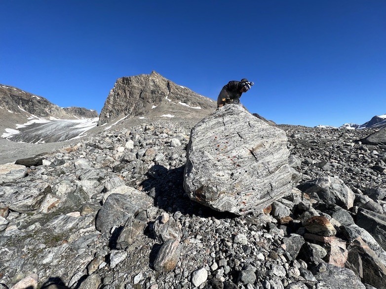 Karlee Prince samples a large glacial erratic